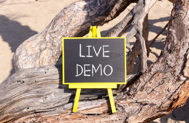 Live demo symbol. Concept words Live demo on beautiful black yellow blackboard. Beautiful tree...