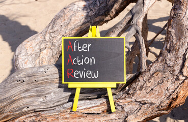 AAR After action review symbol. Concept words AAR After action review on beautiful yellow blackboard. Beautiful old tree background. Business AAR after action review concept. Copy space.