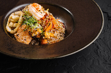 Exquisite gourmet seafood pasta on elegant dark plate