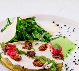 Gourmet stuffed eggplant with fresh greens plate