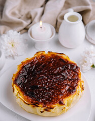 Homemade basque burnt cheesecake on elegant table setting