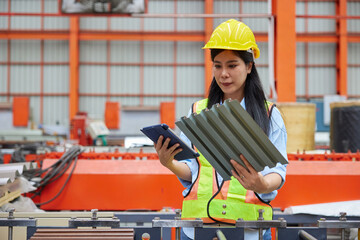 worker or technician holding and checking quality metal sheet in the factory