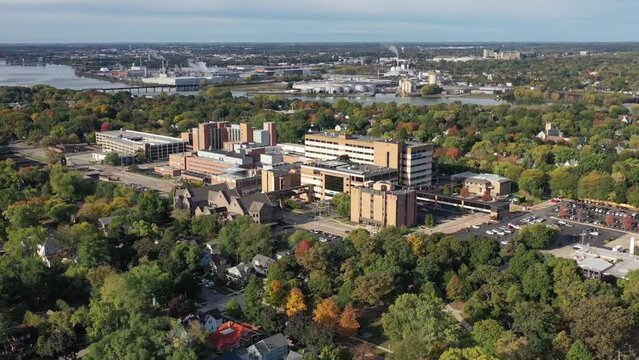 Aerial drone footage of Green Bay, Wisconsin hospitals with Fox River and tree lined streets
