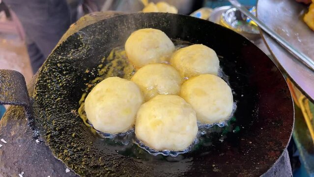 Close up shot of raw Alu Tikki getting prepared at a roadside stall in India.