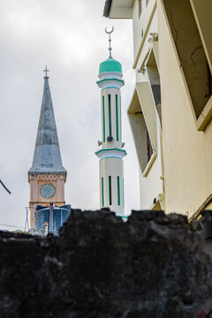 Minaret of Masjid Jibril (Gabriel mosque) and tower of Anglican cathedral at Stone town. Zanzibar, Tanzania