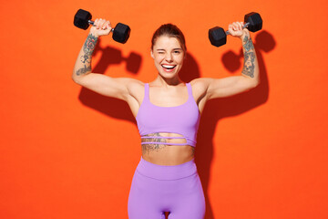Young fitness trainer instructor woman sportsman wear purple top clothes spend time in home gym...