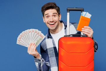 Traveler man wears shirt casual clothes hold bag passport ticket fan f cash money isolated on plain...