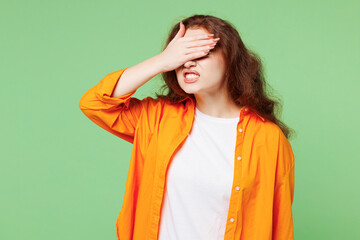 Young sad ginger woman she wear orange shirt white t-shirt casual clothes put hand on face facepalm...