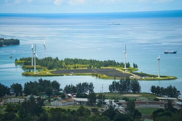 View over the energy island near Mahe, Ile romainville, Romainville Island, an artificial island with solar farm and wind turbines, Mahe Seychelles
