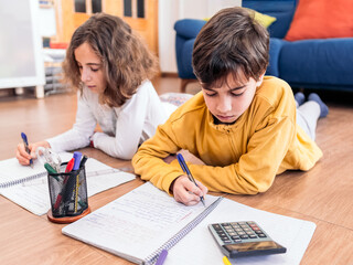 Children Engaged in Homework on Living Room Floor