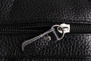 Zipper on black leather bag. Close up of black leather bag.