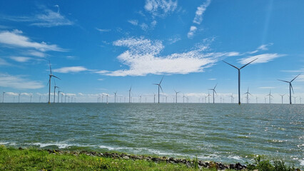 Windmills overlooking large body of water
