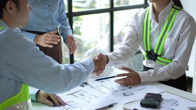Architects talking and shaking hands in a meeting