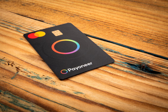 Payment card Payoneer Mastercard on a wooden background