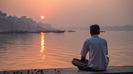 Fototapeta premium A man enjoying a peaceful moment by the Ganges river in Varanasi, India