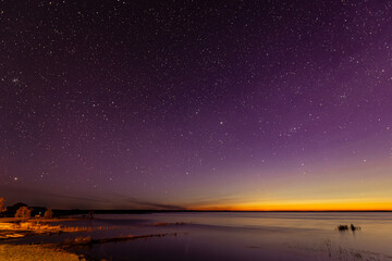 The sky with stars and the glow of the northern lights. Soft selective focus. Artificially created...