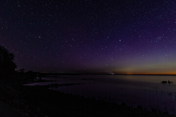 The sky with stars and the glow of the northern lights. Soft selective focus. Artificially created...