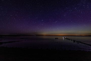 The sky with stars and the glow of the northern lights. Soft selective focus. Artificially created...