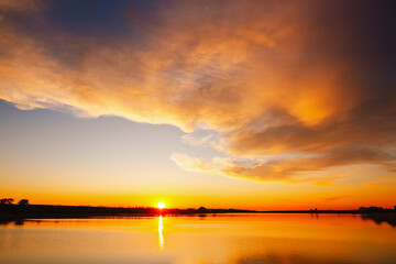 Attractive view of the sunset over the calm surface of the water.