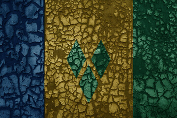 flag of saint vincent and the grenadines on a old grunge metal rusty cracked wall background