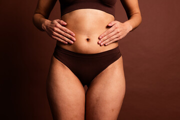 Cropped photo of fatty curvy lady underwear doing stomach massage isolated brown color background