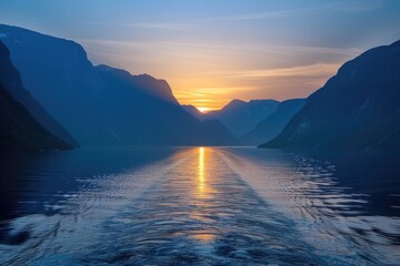 view of a two mountains at the sea and blue clouds at the time of sunset