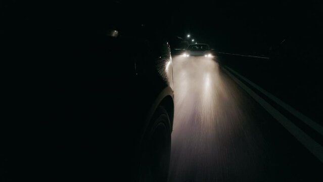 Traffic Patrol Car in Pursuit. Police Officers in Squad Car Chasing Suspect on night Road, Sirens Blazing, High Speed. Cops on Emergency Response Call. Stylish Cinematic Action Packed Shot