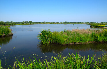 Landscape of a lake and blue sky reflected.
