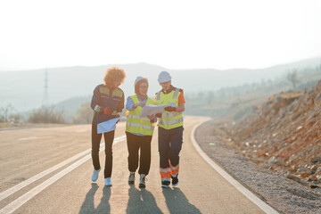 Fototapeta premium A team of engineers and workers oversees a wind turbine project at a modern wind farm, working together to ensure the efficient generation of renewable energy