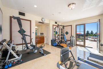Fototapeta premium an empty fitness room with a set of treads and bikes