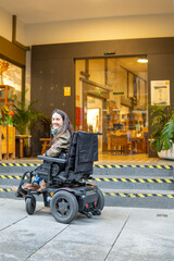 A woman in a wheelchair smiles. Concept of independence and resilience, disability collection