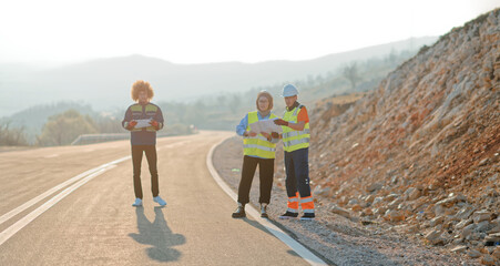 A team of engineers and workers oversees a wind turbine project at a modern wind farm, working together to ensure the efficient generation of renewable energy
