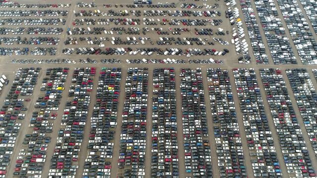 Aerial bird view of automaker car lot showing vehicles parked close to each other ready for further distribution the automotive industry is one of worlds most important economic sectors by revenue