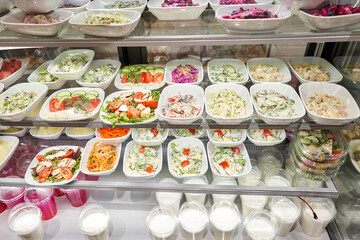 Various salads . Glass Showcase in a buffet or self-service restaurant.