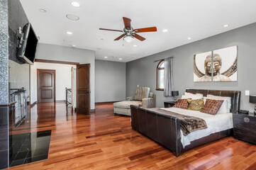 this master bedroom is designed in two colors and features hardwood floors and gray walls