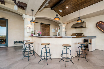 four wooden stools are sitting in a kitchen with white counter tops