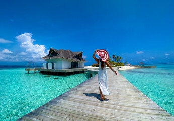 Happy woman lifestyle walking on the bridge in  seashore of Summer tropical at Maldives