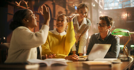 Diverse Group of Students Collaborating on a Project in a Modern Library. Young Adults Engaged in...