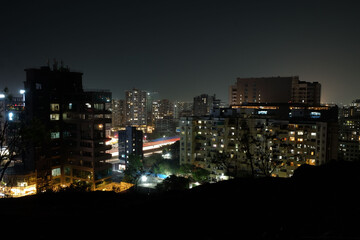 Obraz premium View of Pune in summer, Cityscape Skyline, buildings holdings, Signboards, and banners, Pune, Maharashtra, India