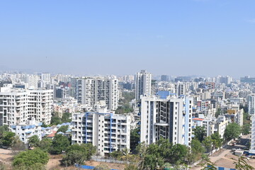 Fototapeta premium View of Pune in summer, Cityscape Skyline, buildings holdings, Signboards, and banners, Pune, Maharashtra, India