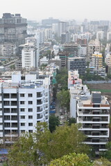 Obraz premium View of Pune in summer, Cityscape Skyline, buildings holdings, Signboards, and banners, Pune, Maharashtra, India