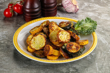 Roasted young zucchini in the plate
