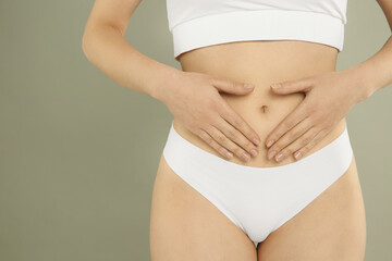 Gynecology. Woman in underwear on grey background, closeup