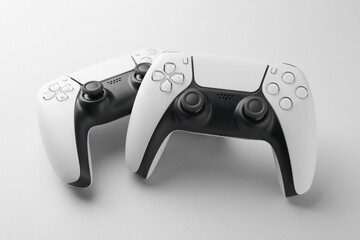 Wireless game controllers on light grey background