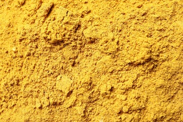 Dry curry powder as background, top view