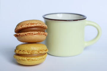Colorful macaroons and cup of coffee on white background.	