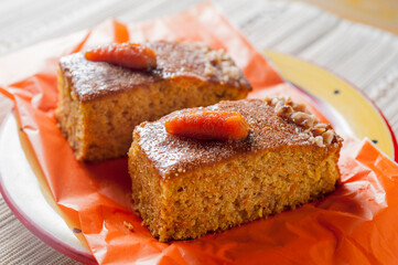 Two portions of carrot and pumpkin cake with nuts