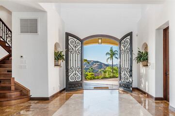 the entry way to a luxurious residence in the mountains is lined with marble floors