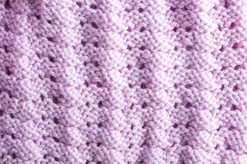 Fragment of hand knitted fabric pink. beautiful pattern. colorful abstract background