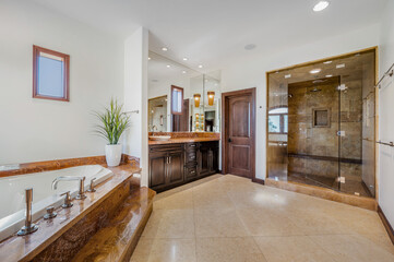 a large bathroom has a massive bathtub in the middle of it